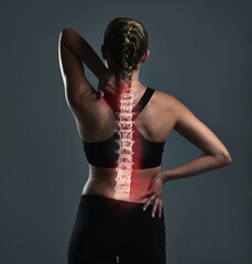 Back pain, woman and fitness with spine injury, wellness and inflammation on grey studio...