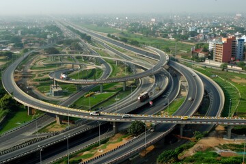 Aerial view of road interchange or highway intersection with busy urban traffic speeding on the road. Junction network of transportation taken by drone