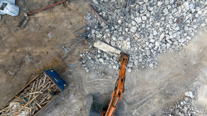 Drone photography pf machinery demolishing a building during spring day