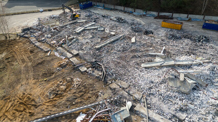 Drone photography pf machinery demolishing a building during spring day