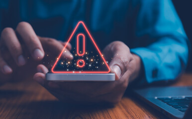 Businessman or it staffs, programmer, developer using Smartphone with triangle caution warning sign...