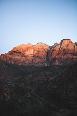 Naklejka premium Blick auf sonnenbeleuchtete Klippe im Zion-Nationalpark bei Dämmerung