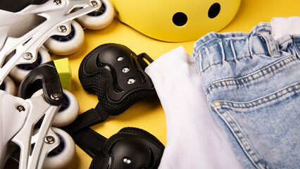 roller skates and body parts protection. top view of inline rollers, helmet, knee pads, wrist...