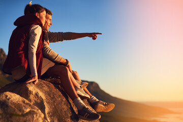 Couple, mountain and outdoor with relax on cliff or point for view, adventure and bonding in nature or environment. Man, woman and together on rock for fresh air, peace and horizon with love on trip.