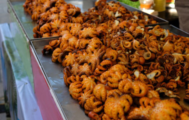 fried octopus on a counter in a street cafe, Thailand