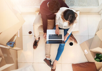 New home, laptop and above of couple with box on floor for property, moving day and mortgage....