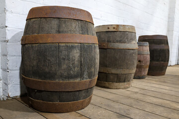 Fototapeta premium Old wine barrels, casks in historic farm building with hardwood floors, near town of Toodyay, Wheatbelt region, Western Australia