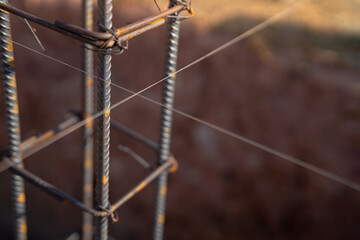 Rebars for concrete foundations at a construction site. Steel bars and iron structure ready for concrete casting. Essential materials and techniques for reinforced concrete in new building projects.