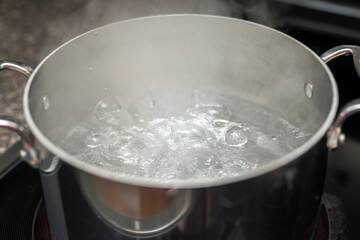 Boiling pot of water, metal pot with water ready for pasta