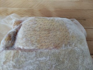 Piece of frozen pork lard in a vacuum packaging