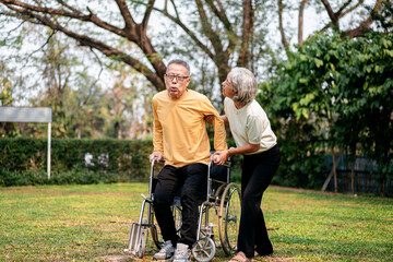 A man in a wheelchair is being helped by a woman