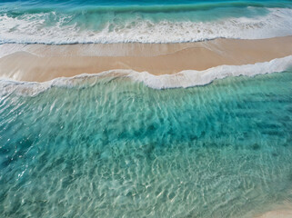 Turquoise waves gently lap against a sandy tropical beach under a clear blue sky