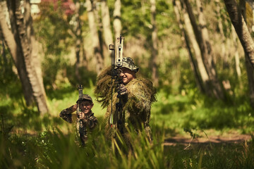 Bow, camouflage or hunting with father and son in forest for getaway, leisure or weekend hobby....