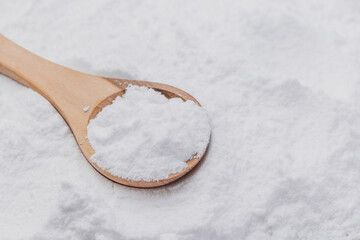 Baking soda on wooden spoon, close-up
