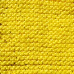 Handmade knitted fabric yellow wool background texture