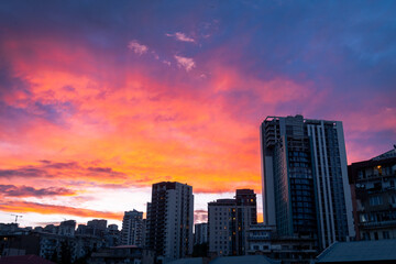 Obraz premium Aerial sky view real estate building facades in Tbilisi, Georgia capital on sunset. Property big city development and high rise buildings. Beautiful Tbilisi sunset banner concept.