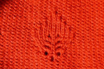 Handmade knitted fabric orange or red wool background texture