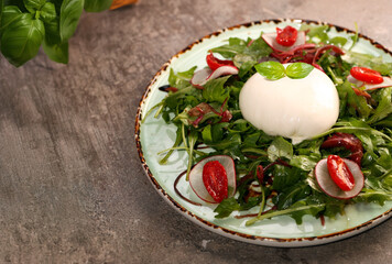 salad with burrata cheese on a plate