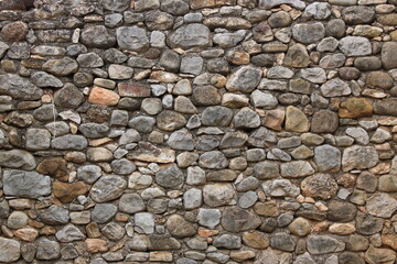 Stone wall in an old abandoned and ruined house