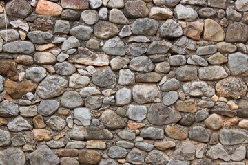 Stone wall in an old abandoned and ruined house