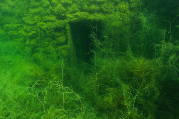 Underwater photo by a diver, the entrance to the flooded rummu prison, a dangerous place.