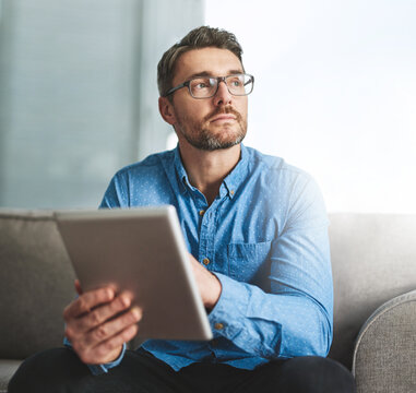 Online, tablet and man with glasses, thinking and ideas of genre in office. Freelancer, digital and screenwriter with story to write for business, website and creative for ebook, couch and person