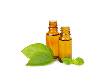 Basil essential oil isolated on white background. Basil essential oil and fresh leaves. Aromatherapy. Aroma oil. Medical herbs. Alternative medicine. Place for text. Copy space.