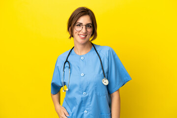 Surgeon doctor woman isolated on yellow background laughing