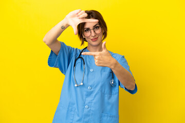 Surgeon doctor woman isolated on yellow background focusing face. Framing symbol