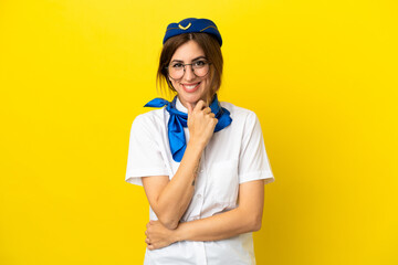 Airplane stewardess woman isolated on yellow background with glasses and smiling