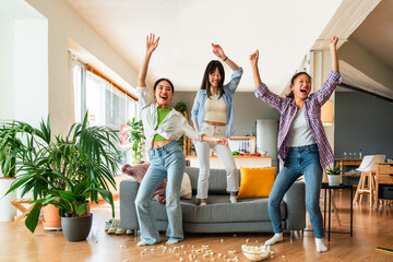 Happy beautiful chinese women friends bonding at home