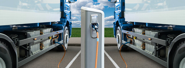 Electric trucks batteries are charged from the charging station. Concept.