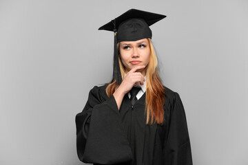 Young university graduate girl over isolated background having doubts