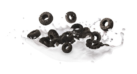 Delicious crunchy black cereal rings with milk splashes falling in the air isolated on white background. High resolution food levitation or zero gravity conception.