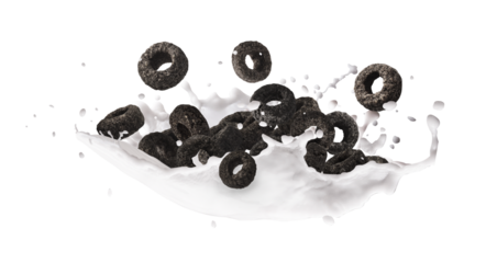 Delicious crunchy black cereal rings with milk splashes falling in the air isolated on white background. High resolution food levitation or zero gravity conception.