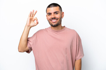 Fototapeta premium Young caucasian man isolated on white background showing ok sign with fingers