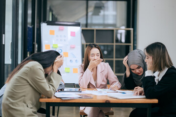 Professional team at and both male and female members participated in a lively brainstorming session at the company office. They collaborate on creative projects using modern technology.