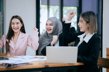 Professional team at and both male and female members participated in a lively brainstorming session at the company office. They collaborate on creative projects using modern technology.