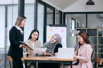 Professional team at and both male and female members participated in a lively brainstorming session at the company office. They collaborate on creative projects using modern technology.