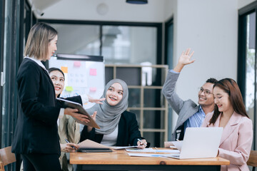 Professional team at and both male and female members participated in a lively brainstorming session at the company office. They collaborate on creative projects using modern technology.