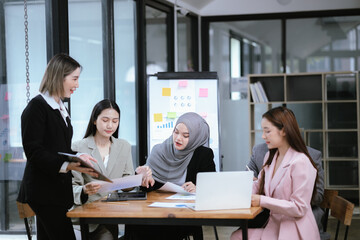 Professional team at and both male and female members participated in a lively brainstorming session at the company office. They collaborate on creative projects using modern technology.