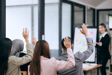 Professional team at and both male and female members participated in a lively brainstorming session at the company office. They collaborate on creative projects using modern technology.