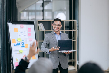 Fototapeta premium Professional team at and both male and female members participated in a lively brainstorming session at the company office. They collaborate on creative projects using modern technology.