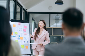 Fototapeta premium Professional team at and both male and female members participated in a lively brainstorming session at the company office. They collaborate on creative projects using modern technology.