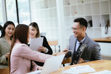 Professional team at and both male and female members participated in a lively brainstorming session at the company office. They collaborate on creative projects using modern technology.