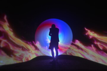 One person standing alone against a Colourful circle light painting as the backdrop