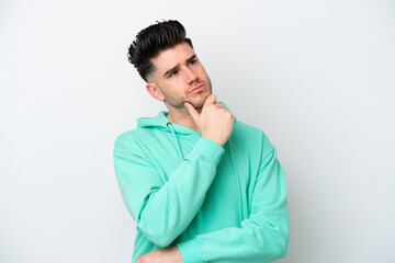 Young caucasian man isolated on white background having doubts