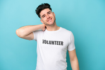 Young volunteer caucasian man isolated on blue background laughing