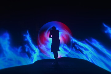 One person standing alone against a Colourful circle light painting as the backdrop