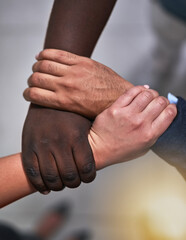 Fototapeta premium Partnership, hands and people holding arms for unity, collaboration or support for team building. Solidarity, diversity and group of friends with hope, community and connection for empathy from above